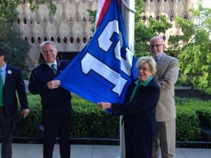 Mayor Ed Murray and Council Members Jean Godden and Tim Burgess raise the 12s flag for kick off 2014. 